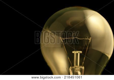 Light bulb close up shot isolated on black.