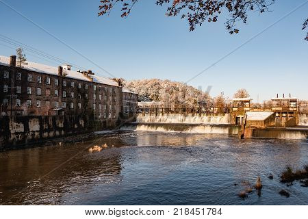 Prattville Alabama USA - December 9 2017: Historic Pratt Cotton Gin Company and spillway in downtown Prattville after a rare snow storm.