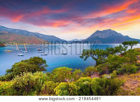 Picturesque Mediterranean seascape in Turkey. Colorful spring sunrise in Adrasan bay with view of Moses Mountain. District of Kemer Antalya Province. Artistic style post processed photo.