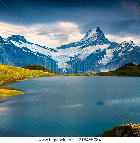 Wetterhorn and peak over Bachsee lake. Dramatic summer scene in Bernese Oberland Alps Grindelwald location Innertkirchen Switzerland Europe.