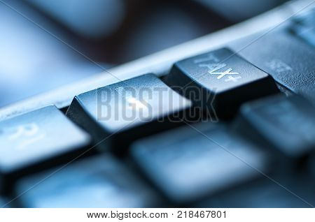 Calculator close up shot, increasing taxes conceptual image in blue light.