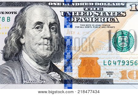 Macro shot of a brand new one hundred dollar bill showing the face of Benjamin Franklin.