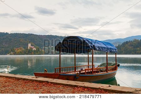 Lake Bled and the island with the church and traditional wooden Pletna at autumn in Slovenia