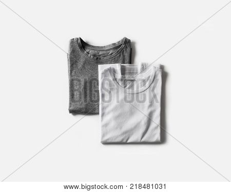 Blank folded white and gray t-shirts. Tshirt mockup for your own graphics. Flat lay.