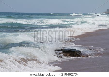 Ocean waves and beach with sand in South Afrika