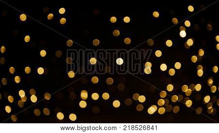 Beautiful Overlay bokeh light texture for design. Gold confetti scatter on black background. Holiday disco pattern for backdrop. Can use for decoration Festive cards banners flyers