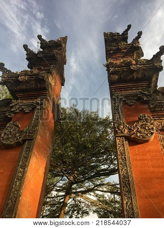 The orange gates of a balinese temple shot at the 6th of july in Bali.