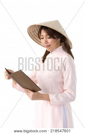Beautiful Woman In Pink Dress And Vietnam Hat Holding Book. Isolated Background With Clipping Path.