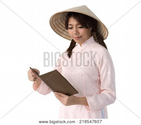 beautiful woman in pink dress and vietnam hat holding book. isolated background with clipping path.
