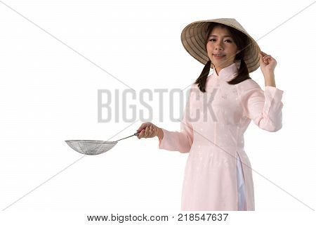 beautiful woman in pink dress and vietnam hat holding cooking utensils. isolated background with clipping path.