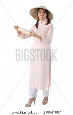 beautiful woman in pink dress and vietnam hat holding rolling pin. isolated background with clipping path.