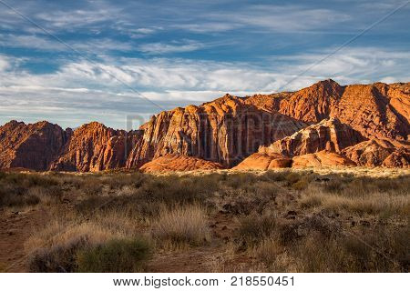 Spectacular sunrise illumination of the Navajo Sandstone mountains of Snow Canyon State Park in Utah.