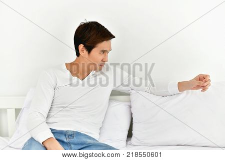 Men are playing mobile in the bedroom.