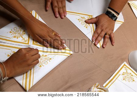 Asian women are practice folding the fabric nepkin.Thailand.