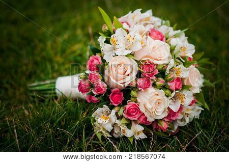 Wedding Rings Lying On The Flower Bouquet