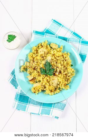 Indian biryani with chicken, yogurt and spices in a plate on a wooden table. New Year's, Christmas dish