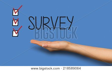 Conceptual survey background. Caucasian hand over analysis backdrop with text and marked checkboxes. Feedback, questionnaire and opinion poll concept, copy space