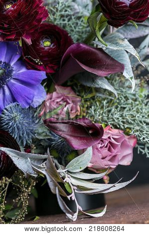 greening, celebration, decoration concept. despite high diversity of such flowers as roses, lilies, anemons and battercups, wedding bouquet looks wonderful and harmonious