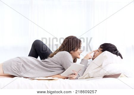 young asian couple in love hug each other on the white bed in bedroom. Romantic couple enjoying in moments of happiness. Love and enjoy dating romance Lifestyle concept