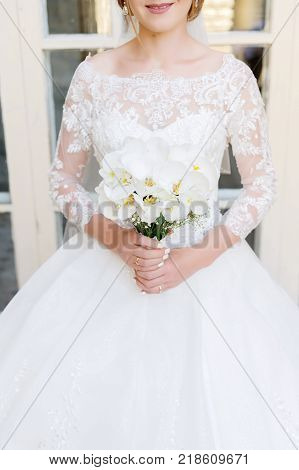 close-up of a bride holding a wedding bouquet. The concept of a wedding festival and a happy life
