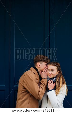 secret love confession. Young boy whispers about his feelings to a girlfriend. Sweet teenage relationship