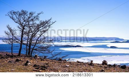 View of the Small Sea Strait and Toynak Island. Far from the right - Olkhon gate strait. On the left is Olkhon Island. Lake Baikal, Russia. April 27th