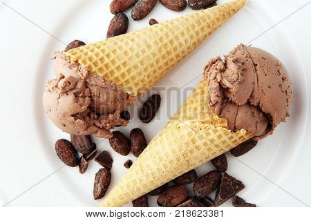 chocolate ice cream scoops with pieces of chocolate and waffle cones