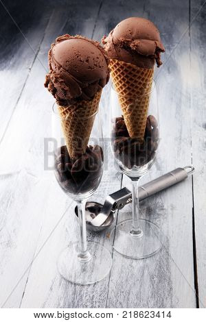 chocolate ice cream scoops with pieces of chocolate and waffle cones