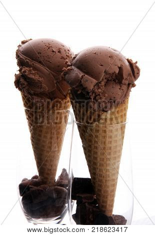 chocolate ice cream scoops with pieces of chocolate and waffle cones