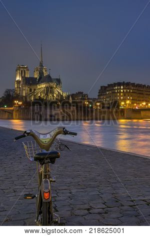 PARIS - December 02 2017:  Velib bicycle at Notre Dame de Paris cathedral. Ile de La Cite  4th Arrondissement Paris France