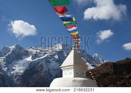 Buddhist white stupa with prayer flags near Namche Bazaar on the way to Everest base camp, Khumbu, Sagarmatha National Park, Nepal Himalayas