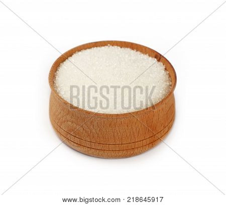Close up one wooden bowl full of white sugar isolated on white background high angle view
