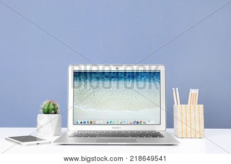 KYIV, UKRAINE - OCTOBER 26, 2017: Apple MacBook Air with desktop screensaver
