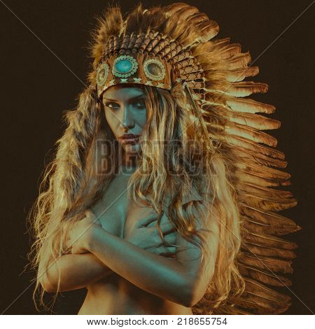 tribal, beautiful girl with plume of american indian feathers