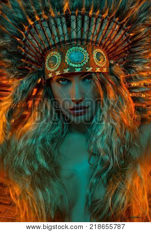 Spirituality, beautiful girl with plume of american indian feathers