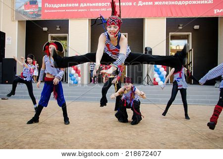 Komsomolsk-on-Amur Russia August 1 2015. Day of the railwayman. A girl in a pirate costume jumps while dancing on the street.