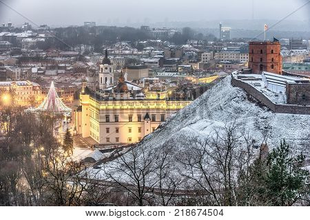 Vilnius, Lithuania: aerial view of the old town,  christmas tree and decorations in Cathedral Square at sunset