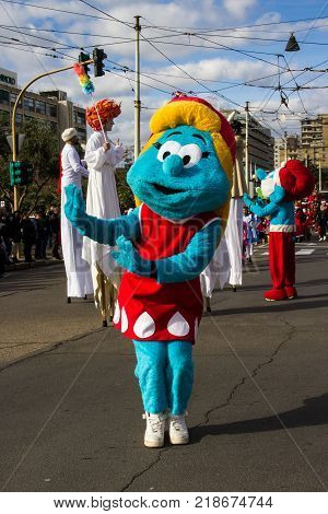 CAGLIARI, ITALY - DECEMBER 8, 2017: Village and parade of Santa Claus, Viale Bonaria - Sardinia (wading jugglers and Disney mascot)