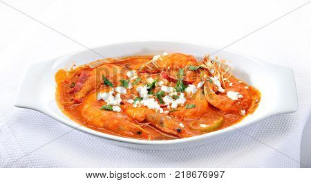 Shrimps with cheese and tomato in a plate