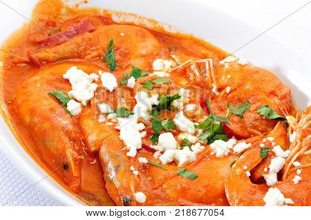 Shrimps with cheese and tomato in a plate