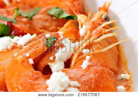 Shrimps with cheese and tomato in a plate
