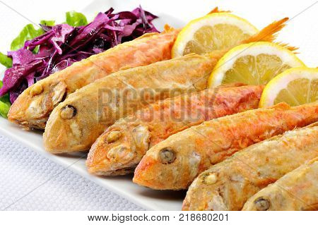 Fried Koutsomoures Greek Fish with vegetables and lemon
