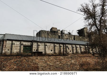Building of the old brick elevator. Old industrial arhitecture.Grunge architecture. Old brick elevator.