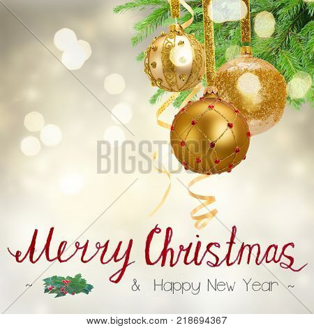 Golden christmas balls and evergreen fir tree on festive background with Merry Christmas greetings