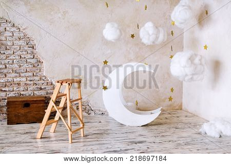 Children's location for a photo shoot. Moon with stars and clouds dreamy decor. Elements of the interior