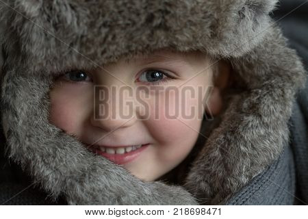 Portrait of a Child in a Fur Hat. Winter Concept