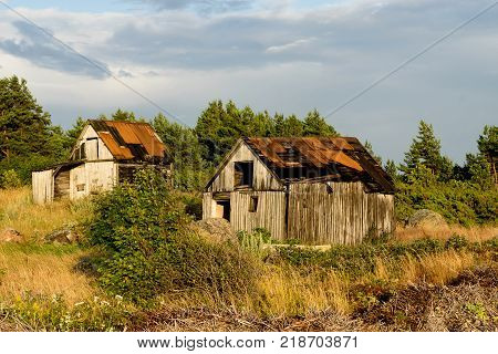 Abandoned houses in the Baltic Sea. Shore, nature and ruins facilities architecture concept. Mohni, small island in Estonia, Europe.