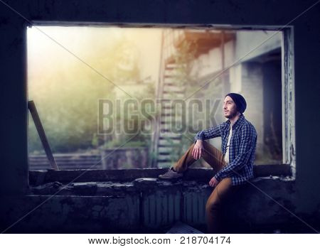 Stalker sitting on the window, abandoned city