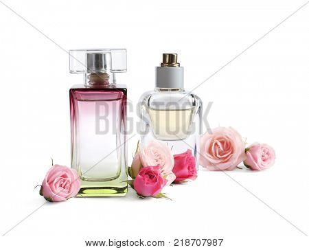 Bottles of perfume with flowers on white background