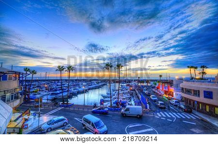 Tenerife, Spain - November 27, 2017: Beautiful night scene over Pinta seaport with colorful sunset in Canary island